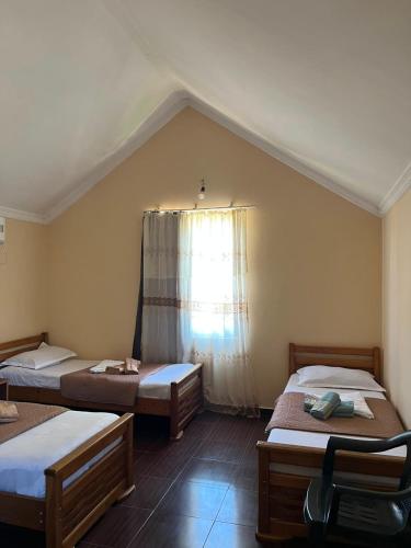 a room with three beds and a window at Liza's house - Block A in Ureki