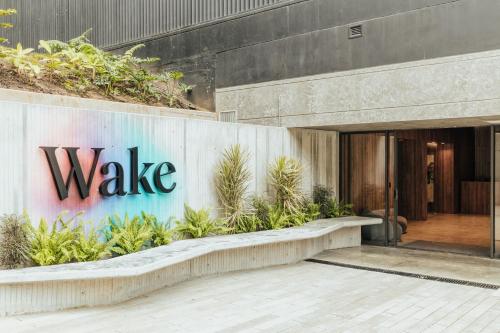 a building with a sign on the side of it at Wake Living in Medellín