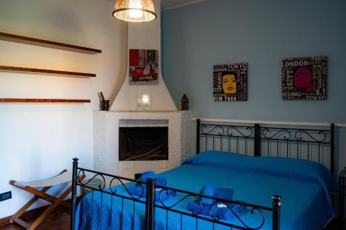 a bedroom with a blue bed and a fireplace at B&B L'Antico Borgo in Milazzo