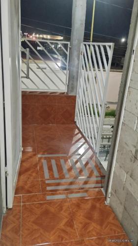 a hallway with a wooden floor and a staircase at Cómodo departamento equipado in Chihuahua