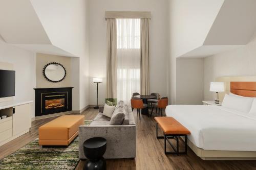 a hotel room with a bed and a fireplace at Le Parc Gatineau, Tapestry Collection by Hilton in Gatineau