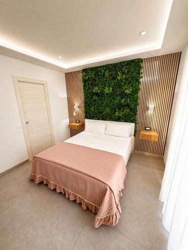 a bedroom with a bed with a green wall at B&B CaMa in Gragnano