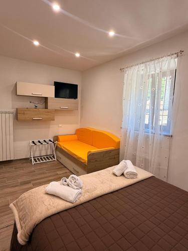 a bedroom with two beds and a television in it at Casa Ma&Emy in Roccaporena