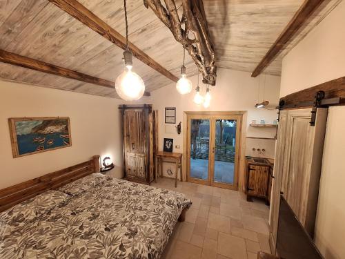a bedroom with a bed and a wooden ceiling at Eco romantica in Baratti