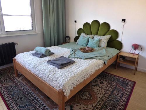 a bedroom with a large bed with towels on it at Kwiat Paproci Design Apartment Gdynia in Gdynia