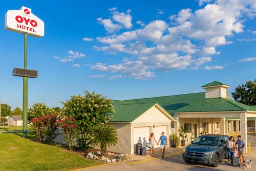 a group of people standing in front of a house at OYO Hotel Yoakum West in Yoakum