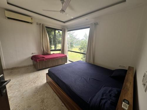 a bedroom with two beds and a window at Rk farms in Noida