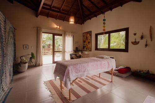 a bedroom with a bed in a room at Casa Viva Itamambuca in Ubatuba
