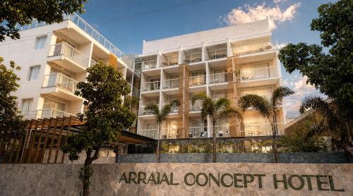 an apartment building with a sign in front of it at Arraial Concept Hotel in Arraial do Cabo