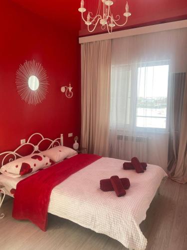 a bedroom with a large bed with red walls at Near Yerevan Serlinhouse in Oshakan
