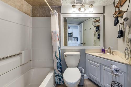 a bathroom with a toilet and a sink and a tub at Pool Access: 8th-Floor Condo on North Myrtle Beach in Myrtle Beach