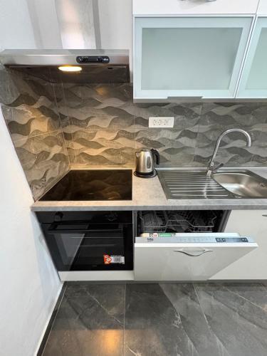 a kitchen with a sink and a counter top at Apartmani "Nikola" Seaview - Ivan Dolac, Hvar in Ivan Dolac