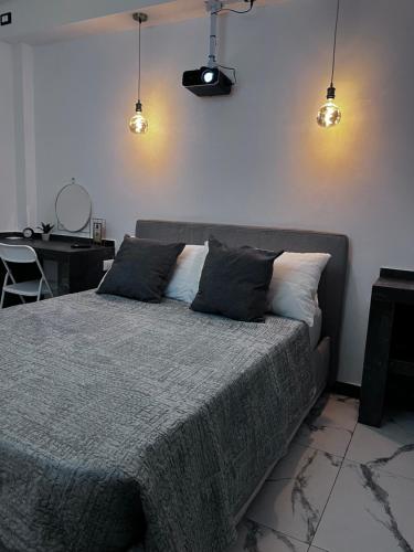 a bedroom with a large bed with two pillows at Maréa suite con giardino in Marina di Carrara