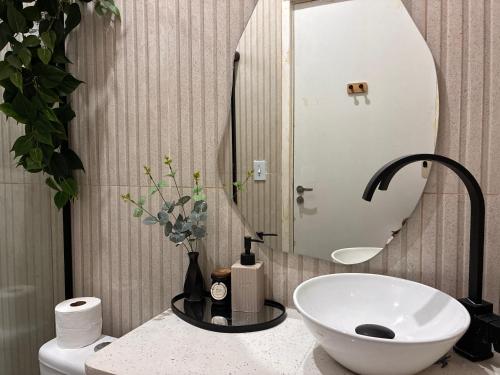 a bathroom with a white sink and a mirror at Hostel Amor por SP - BRÁS in São Paulo