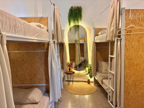 a room with four bunk beds with a mirror at Hostel Amor por SP - BRÁS in São Paulo