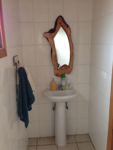 a bathroom with a sink and a mirror at Casa punta de lobos in Pichilemu