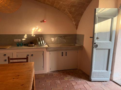 a kitchen with a counter and a sink in a room at Le Guadalupe by Luigi in Volterra