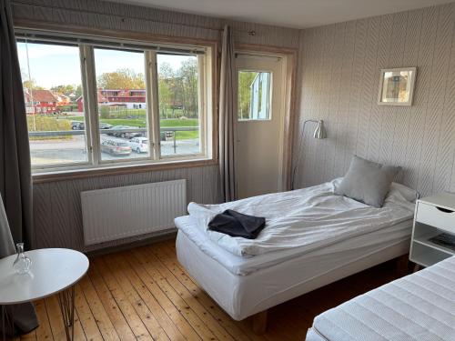 a small bedroom with a bed and a window at Smedjan Bed and Breakfast in Varberg
