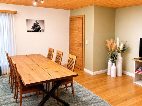 a dining room with a wooden table and chairs at Chasa ARLU in Samnaun