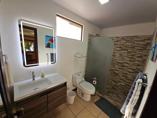 a bathroom with a sink and a toilet and a shower at Outback Hermosa in Playa Hermosa