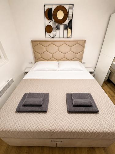 a bedroom with a bed with two towels on it at Emperus Spa in Veliko Gradište