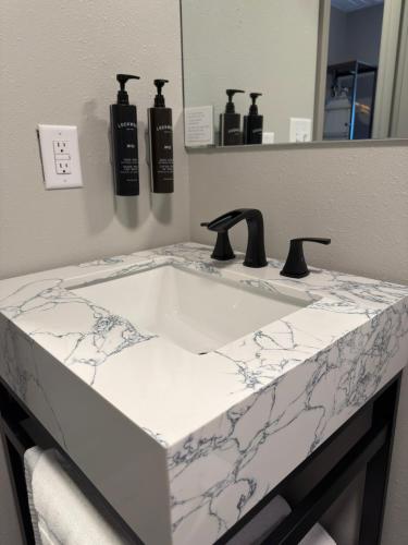 a bathroom sink with a marble counter top at Manistique Sands in Manistique