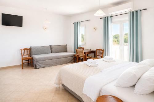 a living room with two beds and a couch at Argo Rooms Antiparos in Antiparos