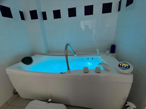 a bathroom with a tub with a faucet at ibis Sète Balaruc les Bains Bien-être et Spa in Balaruc-les-Bains