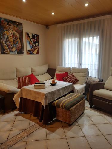 a living room with a couch and a table at Casa Maite in Palamós