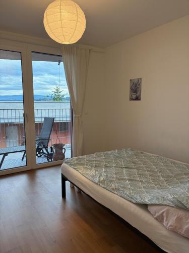 a bedroom with a bed and a view of the ocean at Cozy Apartment in Graz