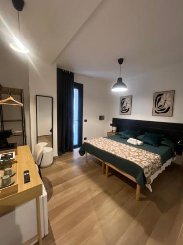 a bedroom with a bed and a desk in it at Ne Ta B&B Ravenna in Ravenna