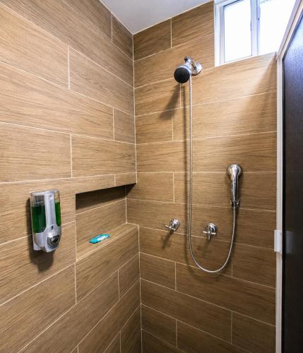 a bathroom with a shower with a shower head at Barrio Inn Morelos in Monterrey