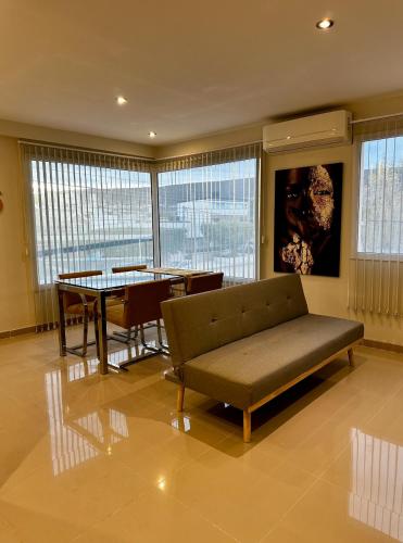 a living room with a couch and a table at House51 "ubicado a solo 3 cuadras de la playa en pleno centro de Rada Tilly" in Rada Tilly