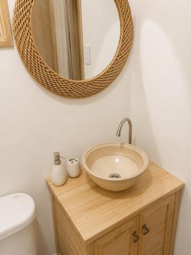 a bathroom with a sink and a mirror on the wall at Alojamiento en Paine cerca Monticello in Hijuela Larga