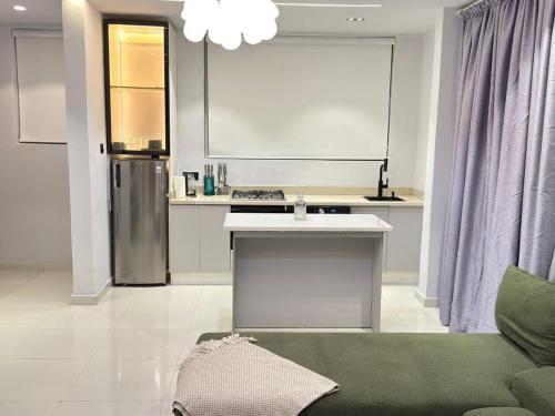 a kitchen with a sink and a refrigerator at Pc Luxury 1 bedroom with pool in Lagos