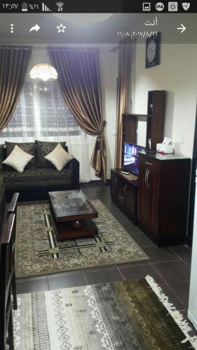 a living room with a couch and a tv at Chalet in sharm el shekh in Sharm El Sheikh