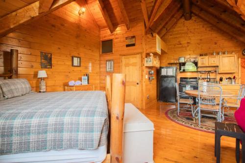 a bedroom with a bed in a wooden cabin at The Nut House in Sevierville