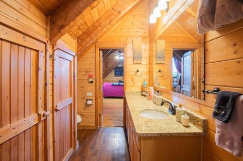 a bathroom with a sink in a wooden cabin at The Nut House in Sevierville