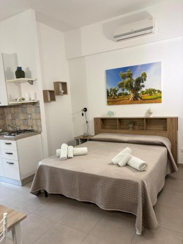 a bedroom with a large bed with towels on it at B&B la Quiete in Leverano
