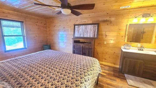 a bedroom with a bed and a ceiling fan at The Burrows in Sevierville