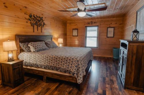 a bedroom with a bed and a ceiling fan at The Burrows in Sevierville