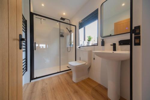 a bathroom with a shower and a toilet and a sink at Am Bothan - Pied-à-terre in Portree
