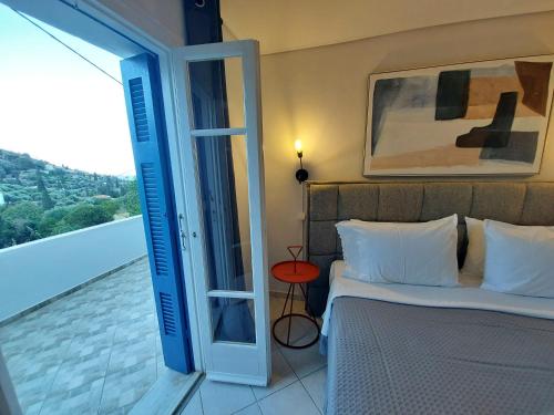 a bedroom with a bed and a door to a balcony at Margarita's Home in Steniaí