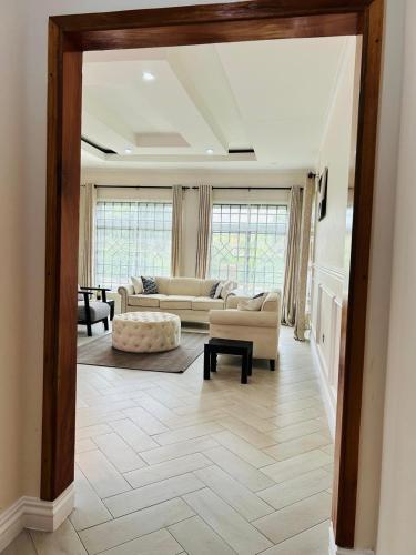 a living room with a couch and a table at Hazina Homes in Boma la Ngombe