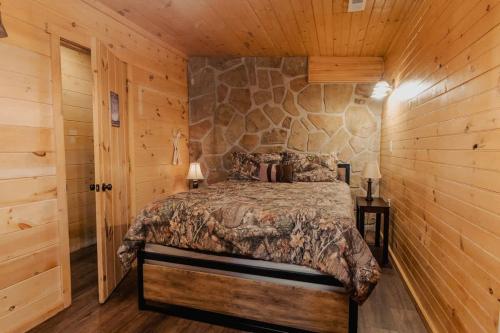 a bedroom with a bed in a log cabin at The Rustic Charm in Sevierville