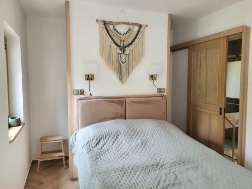 a bedroom with a bed with a wooden headboard at Slow Life Rabka in Rabka-Zdrój