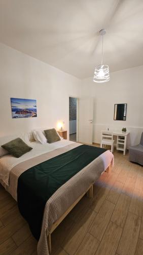 a bedroom with a large bed and a couch at Mare Apartment in Nocera Inferiore