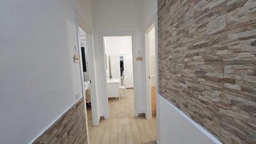 a hallway with a stone wall in a bathroom at Mare Apartment in Nocera Inferiore