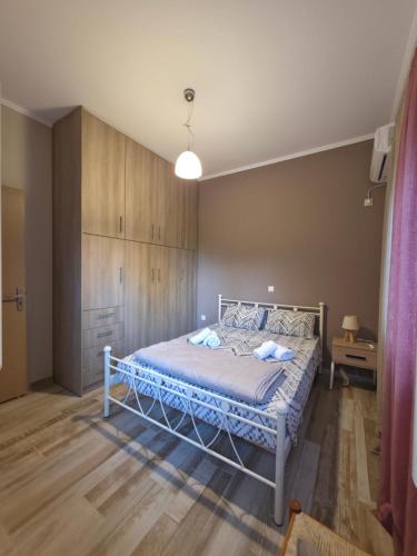 a bedroom with a white bed in a room at Apartment Belle Epoque in Lixouri