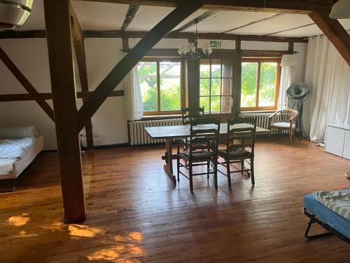 a dining room with a table and chairs in a room at SAAL am Pfarrhaus in Penzlin